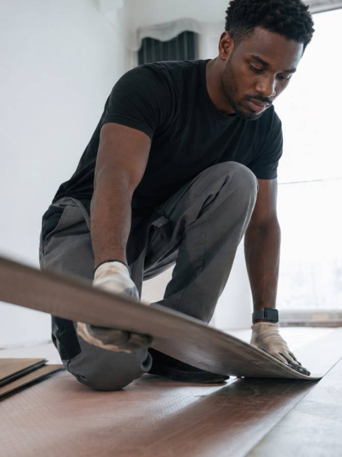 black-man-laying-wood-flooring-in-home-interior-solhub
