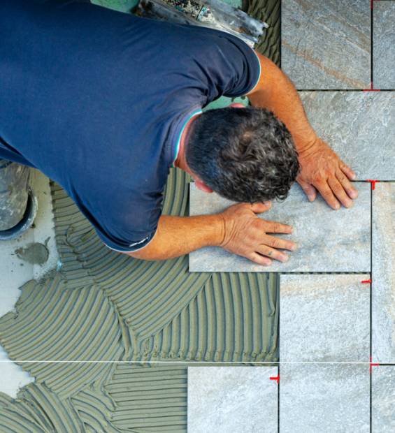 craftsman-installing-stone-floor-tiles-solhub